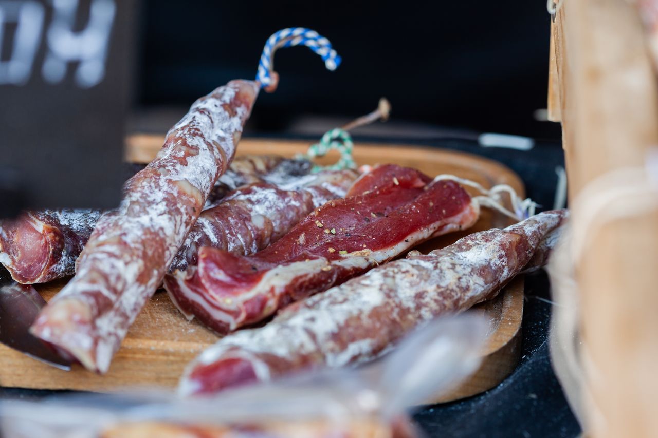 The Art of Drawing Readers In: Your attractive post title goes here Delicious assortment of cured meats displayed on a rustic wooden platter, perfect for gourmet cooking.